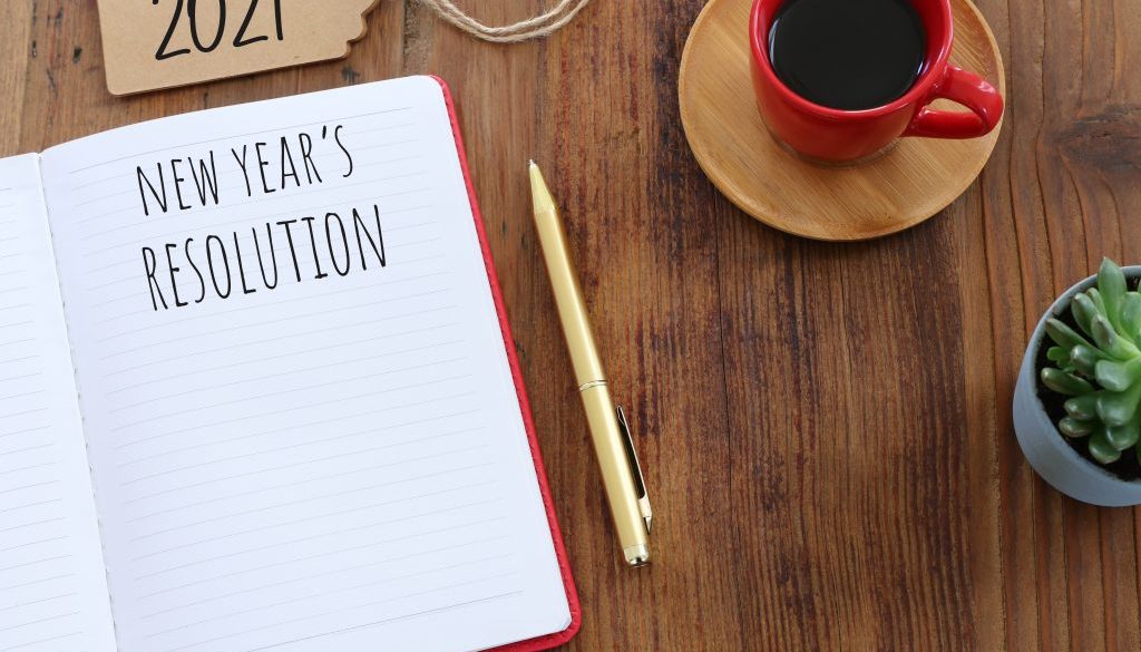 Business concept of top view 2021 resolution with notebook, cup of coffee over wooden desk